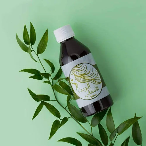Afghani hair oil bottle with green leaves